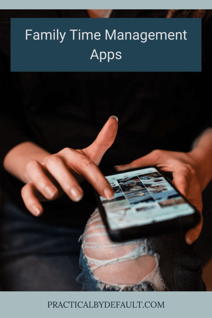 woman holding phone open to apps, phone on her knee ripped jeans.