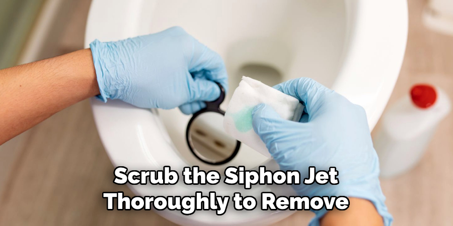 Scrub the Siphon Jet
Thoroughly to Remove