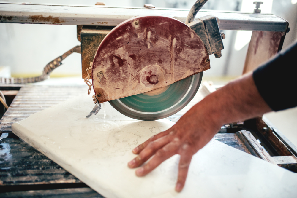man using circular saw for cutting slate and marble