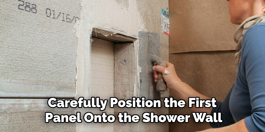 Carefully Position the First
Panel Onto the Shower Wall