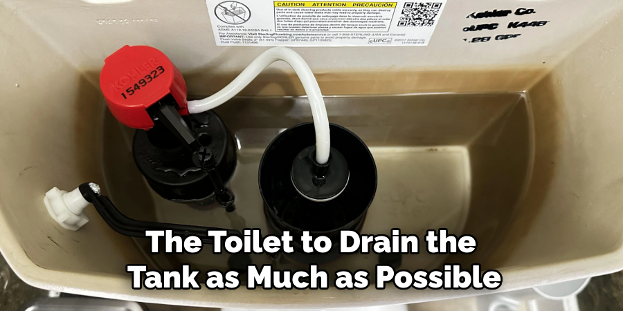 The Toilet to Drain the
Tank as Much as Possible