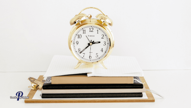 Clock on books how to stop wasting time