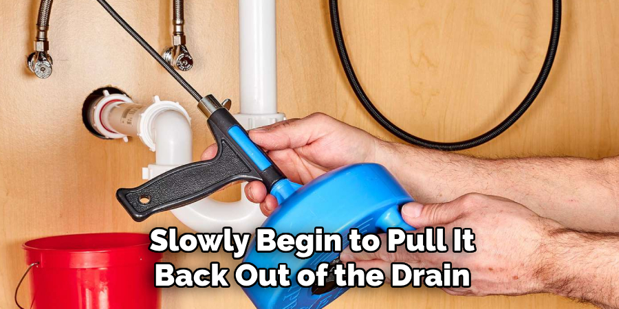 Slowly Begin to Pull It
Back Out of the Drain