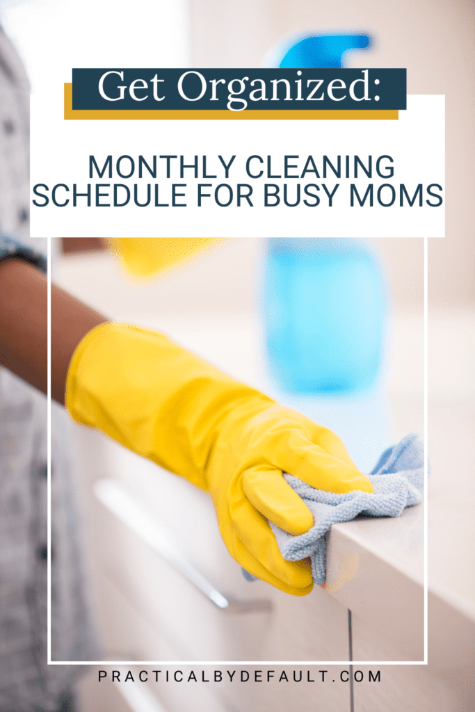 gloved hand cleaning counter, spray bottle on the counter. Monthly cleaning schedule for working moms