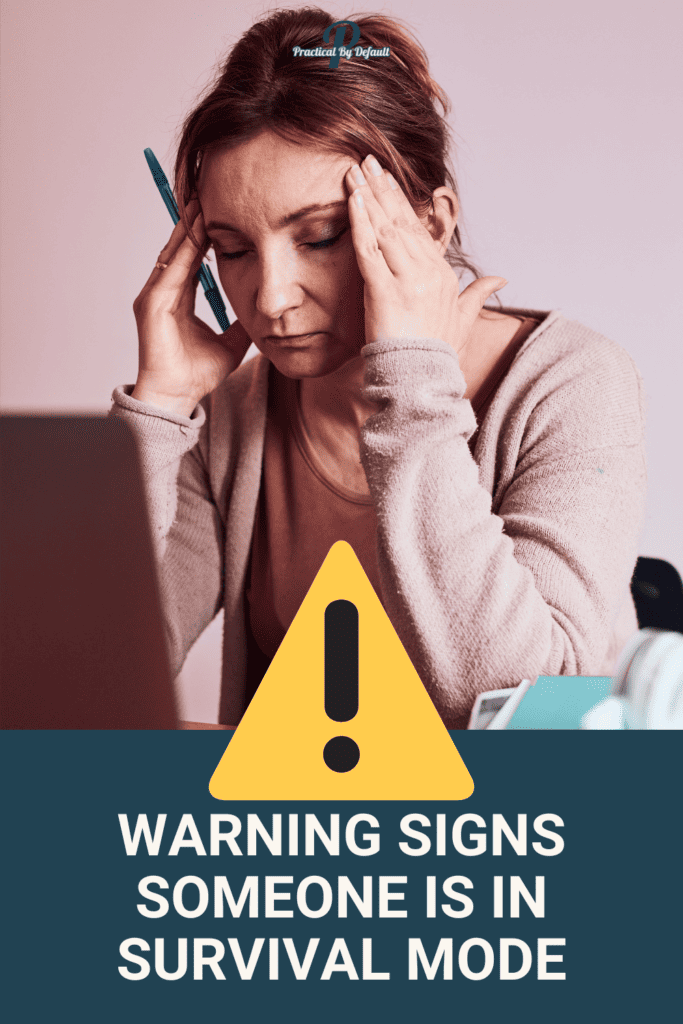 woman sad holding her head at a computer. 20 Signs Survival Mode